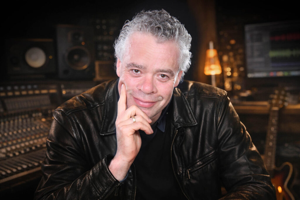 Mekel Haunsby portrait in a recording studio with mixing console and monitors in the background