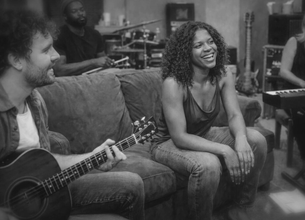 Zaya Haunsby smiling during a rehearsal session with musicians