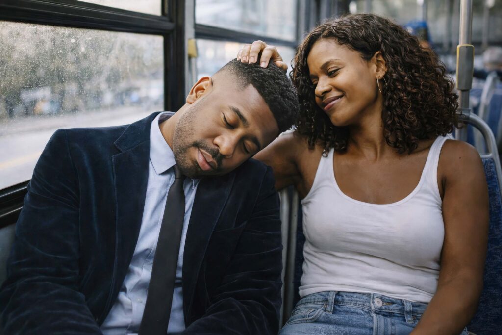 Zaya Haunsby gently resting her hand on Luca Haunsby’s head as he sleeps on public transport